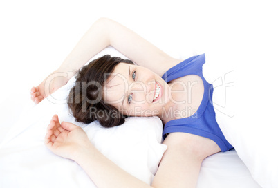Close-up of a smiling woman waking up slowly