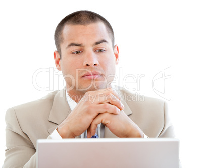 Concentrated businessman using a laptop