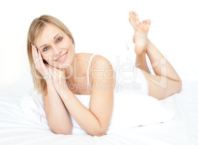 Attractive young woman lying on a bed