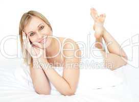 Attractive young woman lying on a bed