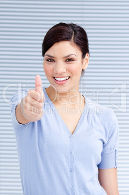 Cheerful businesswoman with a thumb up