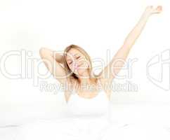 Glowing woman stretching while getting up