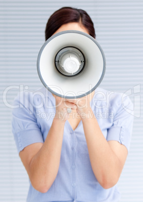 Businesswoman yelling through a megaphone