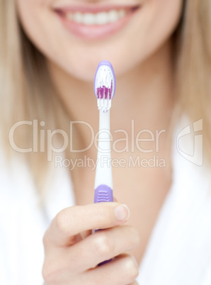 Close-up of a woman holding a toothbrush