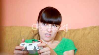 Dolly shot of young woman playing videogames