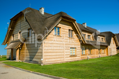 big wooden house with straw roof