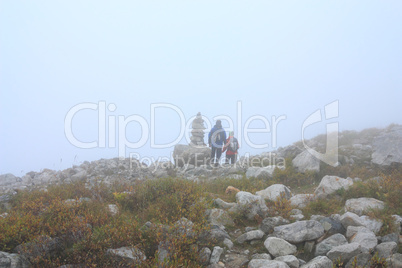 two hikers near the path pointer
