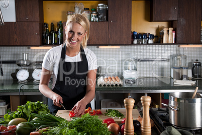 Happy female chef in the kitchen