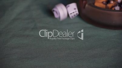 Play dice on green table cover.