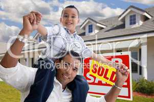 Hispanic Father and Son with Sold Real Estate Sign