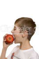 The boy eats an apple