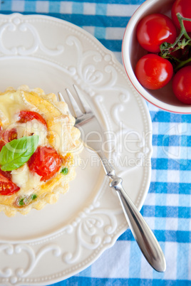 Small pie with brie and tomatoes