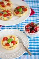 Small pie with brie and tomatoes