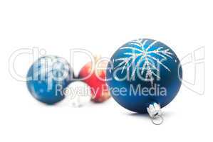 Blue christmas ball on the foreground and group of the blured ba