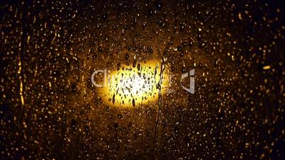 Rain on glass window at night