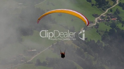 paraglider out of clouds