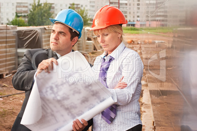 Director with subordinate on construction site