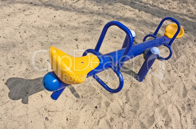 An empty seesaw in a playground