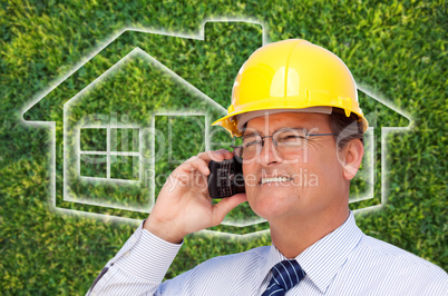 Contractor in Hardhat on Cell Phone Over House Icon and Grass
