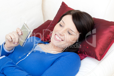 Smiling woman listening music with headphones