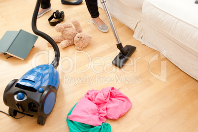 Woman vacuuming the living-room