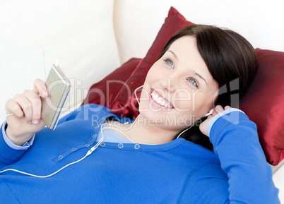 Joyful woman listening music with headphones