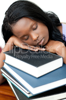 Sleeping student leaning on a stack of books
