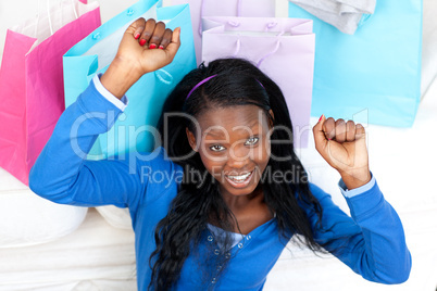 Cheerful woman punching the air in celebration after shopping
