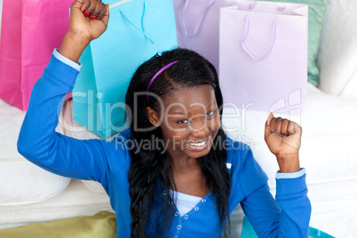 Joyful woman punching the air in celebration after shopping