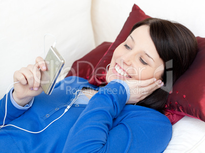 Cheerful woman listening music with headphones
