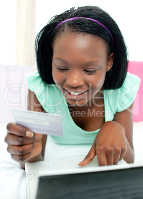 Smiling teen girl shopping on-line