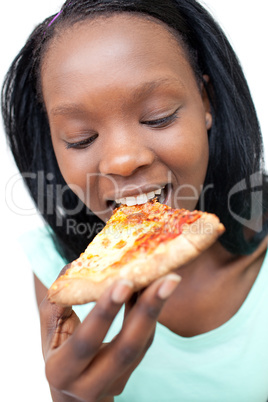 Delighted teen girl eating a pizza