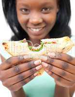 Pretty young woman eating a sandwich