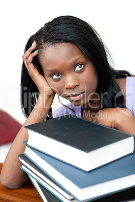 Upset student leaning on a stack of books