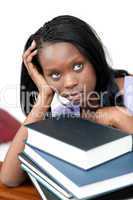 Upset student leaning on a stack of books