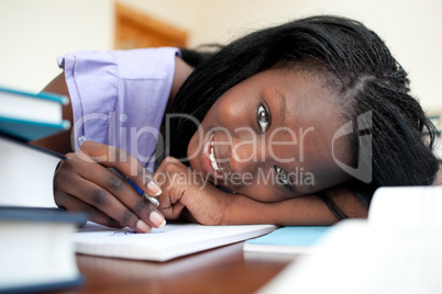 Cheerful teen girl doing her homework