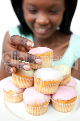 Afro-american woman taking a cake