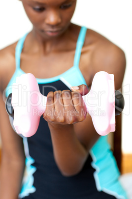Young woman working out with dumbbell
