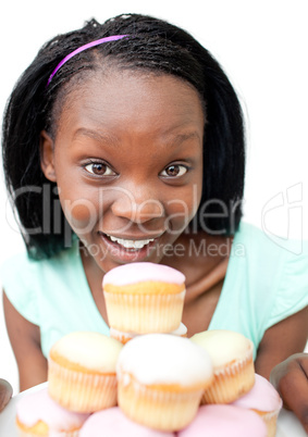 Happy young woman looking at cakes