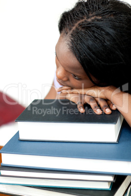 Bored student leaning on a stack of books