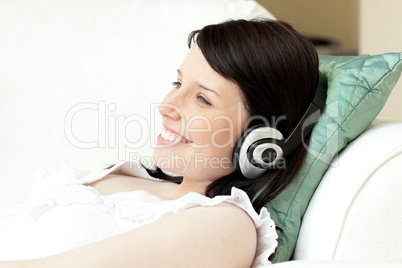 Charming young woman listening music with headphones