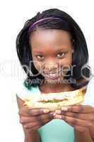 Cheerful young woman eating a sandwich