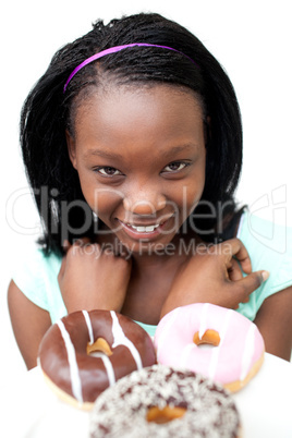 Happy young woman looking at donuts