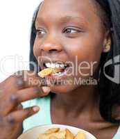 Jolly young woman eating fries