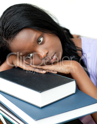 Annoyed student leaning on a stack of books