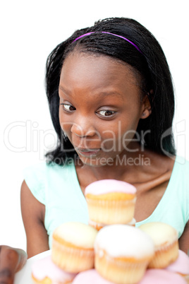 Joyful young woman looking at cakes