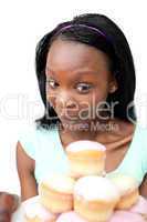 Joyful young woman looking at cakes