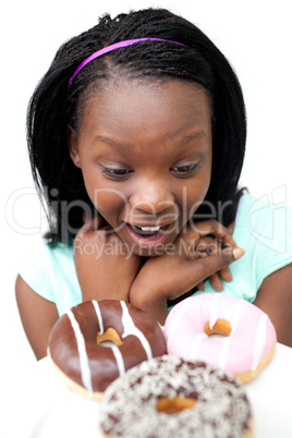 Surprised young woman looking at donuts