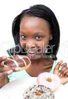 Attractive young woman eating a chocolate donut