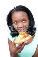 Smiling teen girl eating a pizza